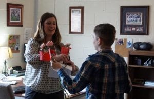 Aden stops by the front office to deliver flowers to the front office staff of PCMS.